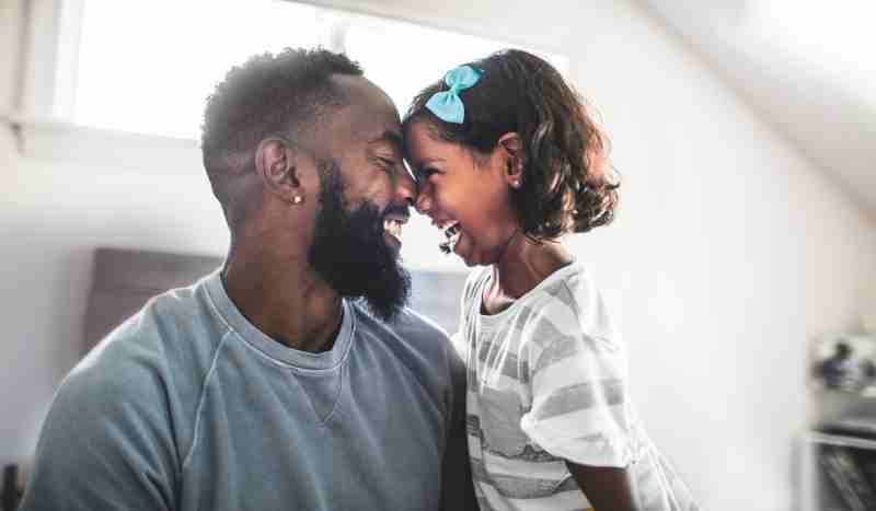 Father wearing ClearCorrect Aligners while playing with his daughter