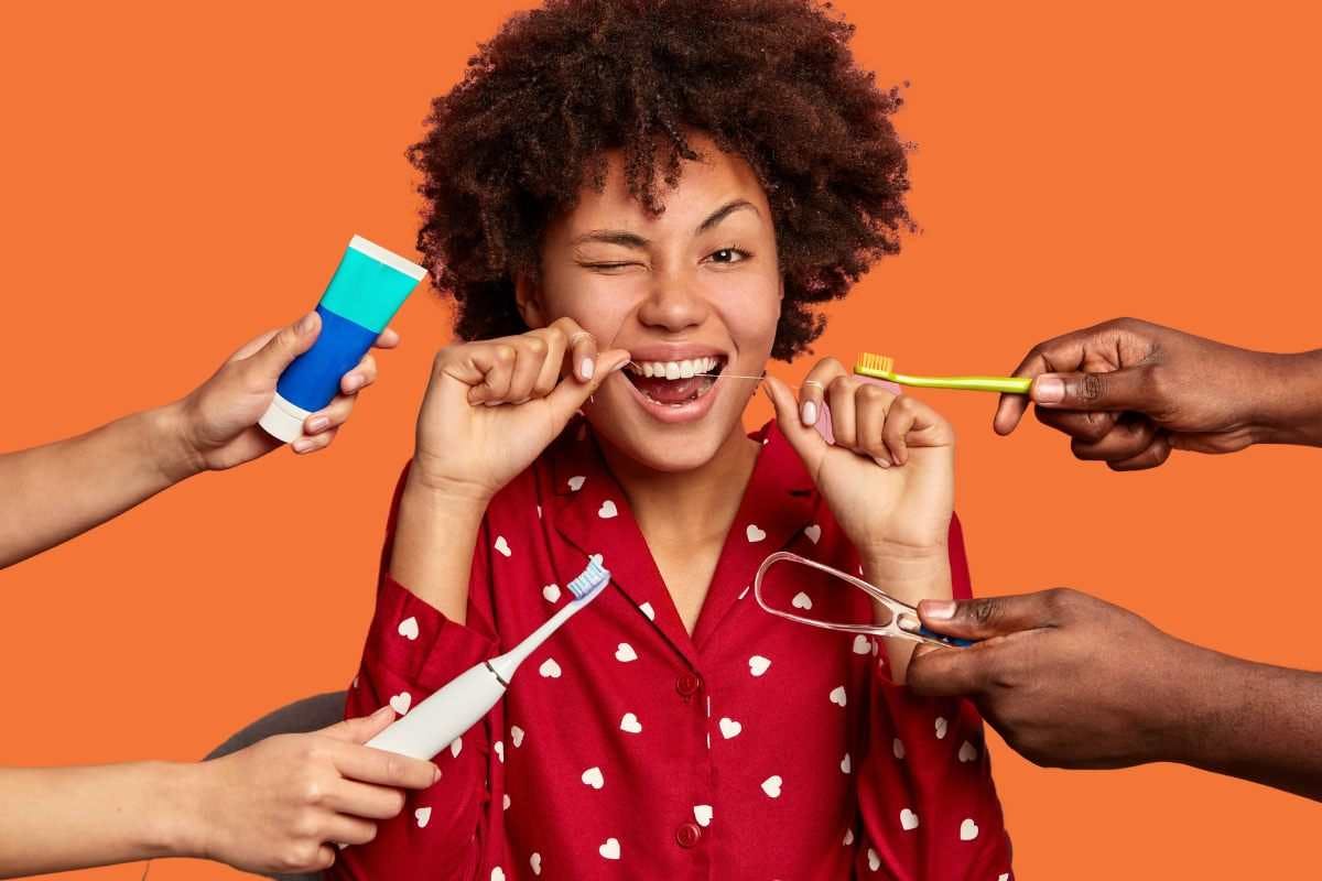 Women being handed multiple different dental hygiene products as she smile and keeps on flossing her teeth